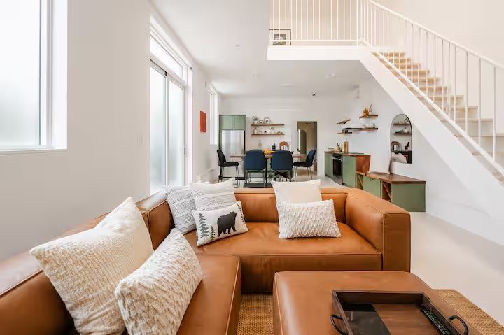 Leather sectional looking toward the kitchen and stairs