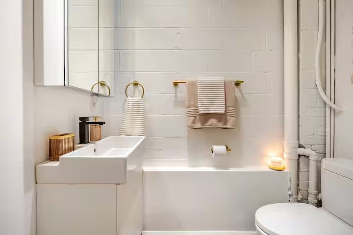 Bathroom with tub, sink and brass fixtures